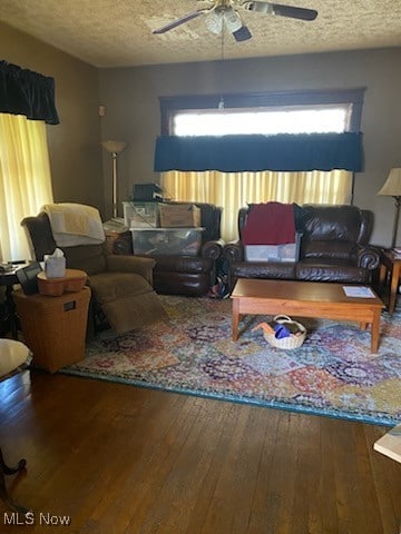 living room featuring hardwood / wood-style floors, a textured ceiling, and ceiling fan