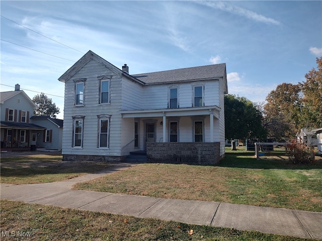 view of front of home with a porch and a front yard