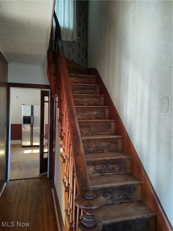 stairway featuring wood finished floors