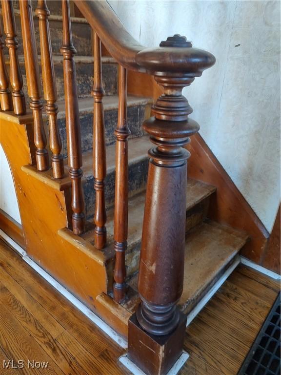 stairway featuring wood finished floors