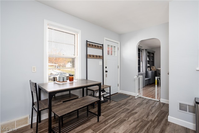 dining space with dark wood-type flooring