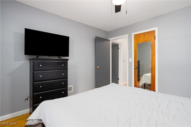 bedroom with hardwood / wood-style flooring and ceiling fan