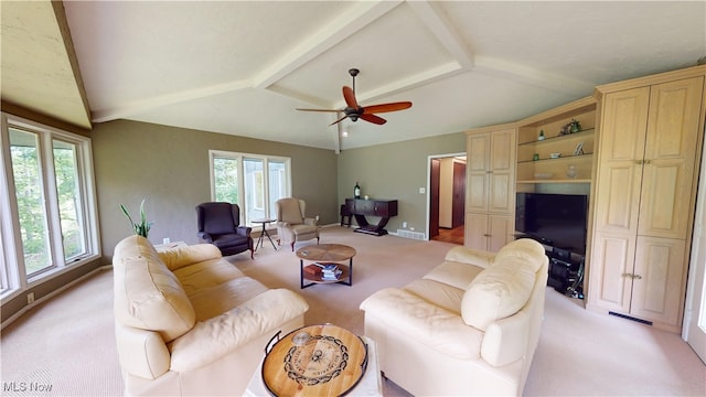 living room featuring a wealth of natural light, lofted ceiling, light colored carpet, and ceiling fan