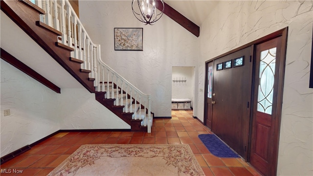 foyer featuring high vaulted ceiling, beamed ceiling, and tile patterned flooring