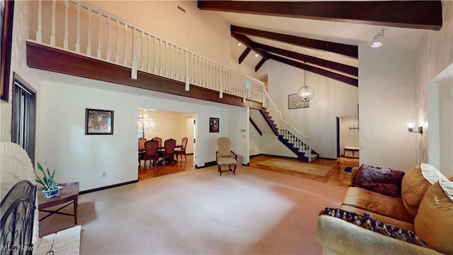 living room featuring an inviting chandelier, beamed ceiling, light wood-type flooring, and high vaulted ceiling