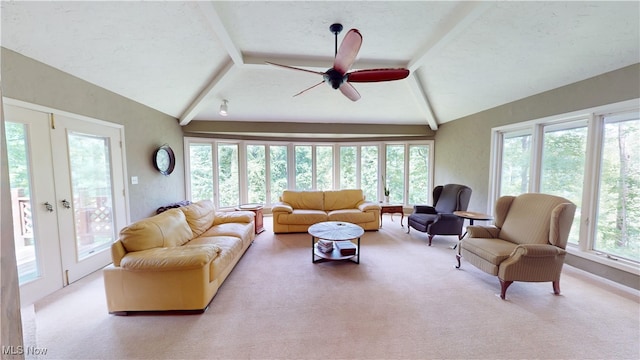 carpeted living room featuring vaulted ceiling with beams, a healthy amount of sunlight, and ceiling fan