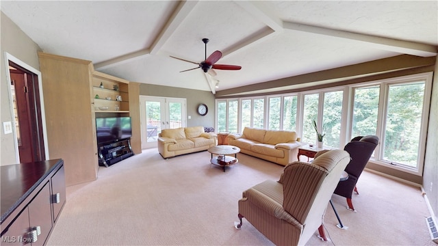 living room featuring vaulted ceiling with beams, french doors, light carpet, and plenty of natural light