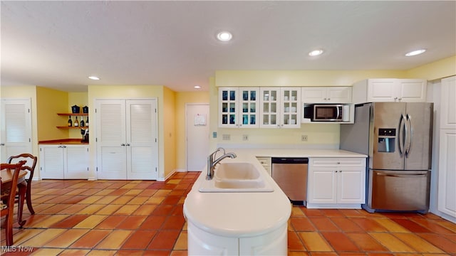 kitchen with white cabinetry, stainless steel appliances, sink, and light tile patterned flooring