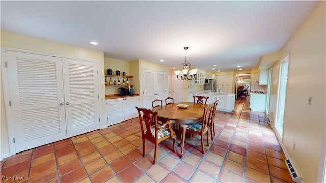 dining room featuring a chandelier and light tile patterned floors