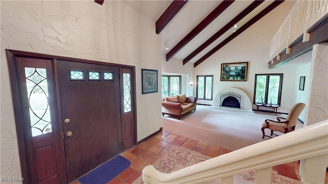 tiled entrance foyer featuring high vaulted ceiling and beamed ceiling