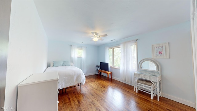 bedroom with hardwood / wood-style floors and ceiling fan