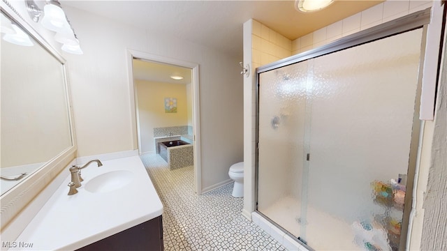 bathroom featuring vanity, toilet, and an enclosed shower