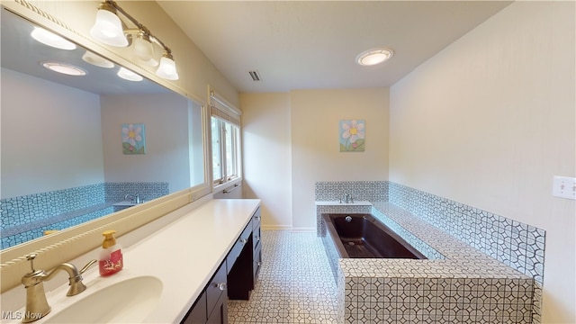 bathroom with vanity, tile patterned flooring, and a bathing tub