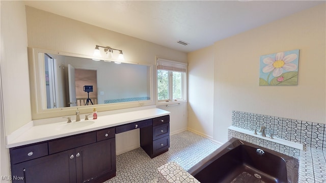 bathroom with vanity, tile patterned floors, and a bath