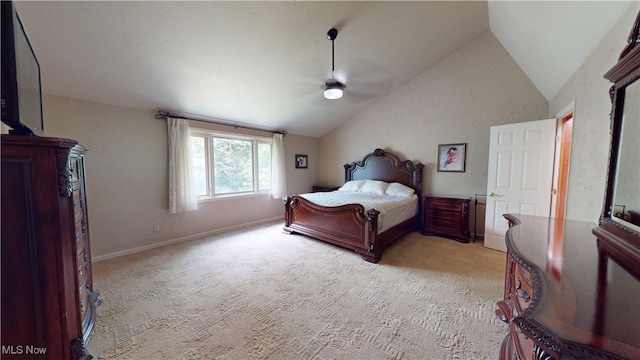 bedroom featuring ceiling fan, light colored carpet, and vaulted ceiling