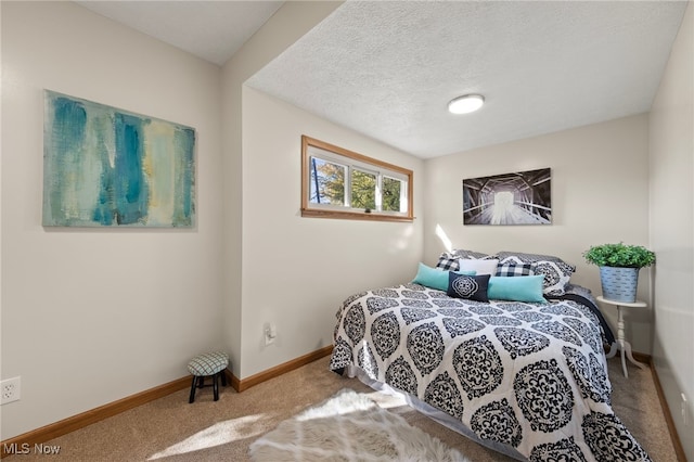 bedroom featuring a textured ceiling and carpet flooring