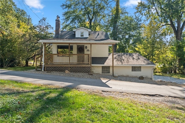 back of property with a porch