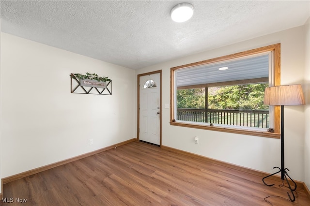 entrance foyer with hardwood / wood-style flooring and a textured ceiling