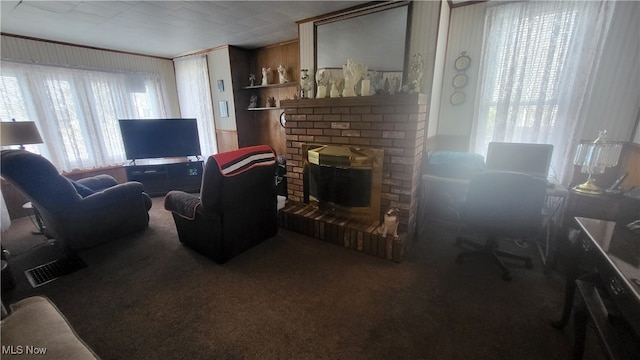 carpeted living room with wooden walls and a fireplace