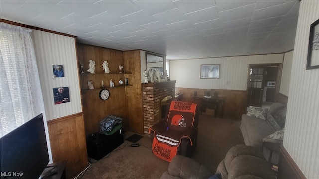 living room featuring wooden walls and carpet