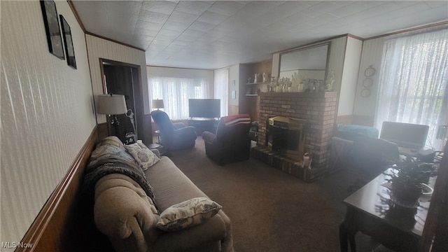 living room with crown molding, carpet, and a fireplace