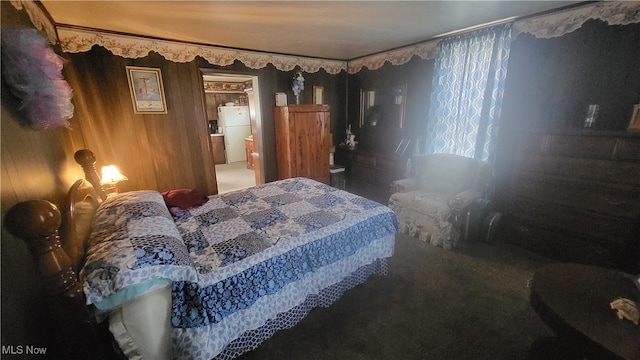 carpeted bedroom with white refrigerator