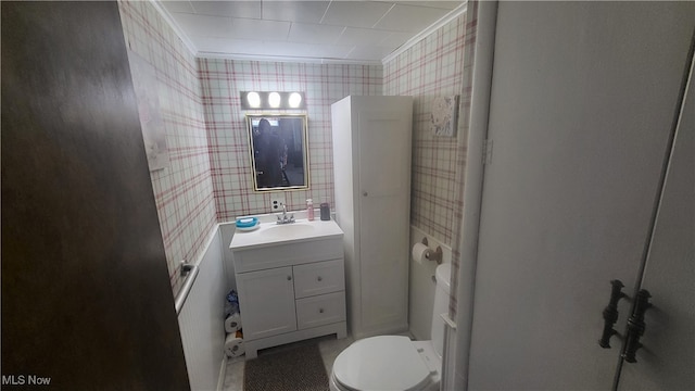 bathroom with vanity, ornamental molding, and toilet