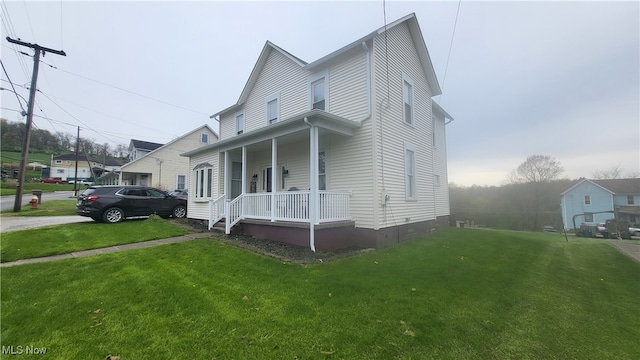 view of front of house with a front yard and covered porch