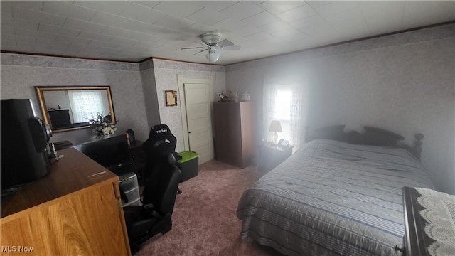 bedroom featuring dark colored carpet, crown molding, and ceiling fan