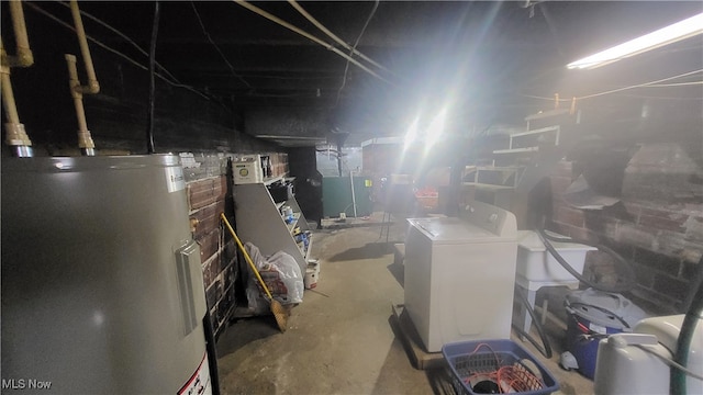 basement featuring washer / clothes dryer and water heater