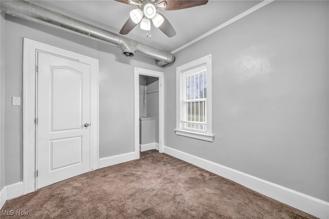 unfurnished bedroom featuring crown molding, carpet flooring, and ceiling fan