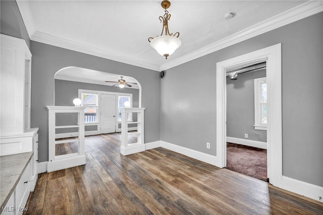 unfurnished living room featuring ornamental molding, dark hardwood / wood-style floors, and ceiling fan