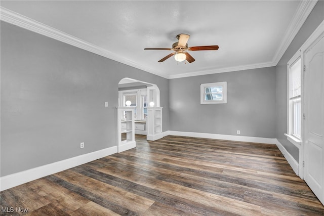 empty room featuring crown molding, dark hardwood / wood-style floors, and ceiling fan