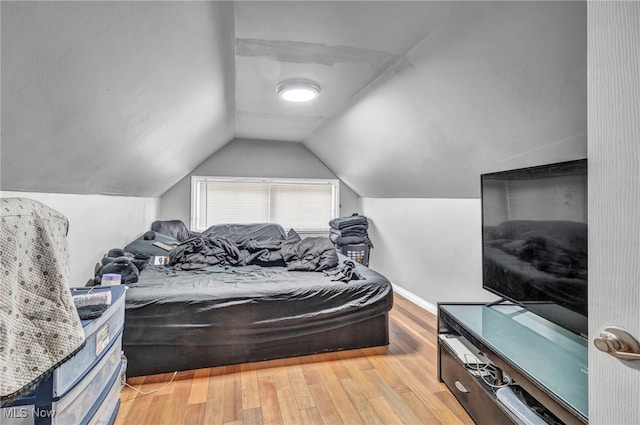 bedroom with light hardwood / wood-style flooring and vaulted ceiling