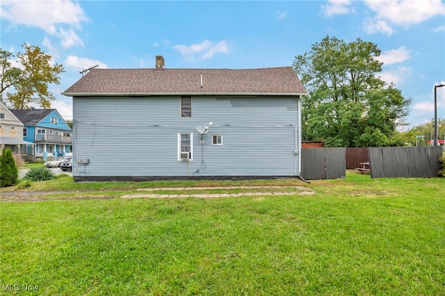 rear view of house with a lawn