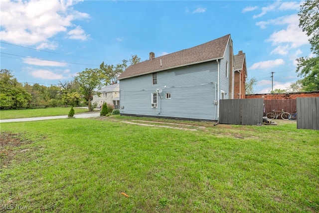 rear view of house with a yard