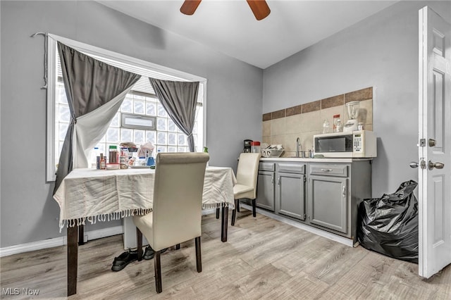 dining area featuring light wood finished floors and ceiling fan