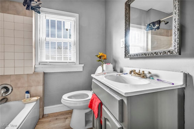 full bathroom with vanity, toilet, wood-type flooring, and plenty of natural light