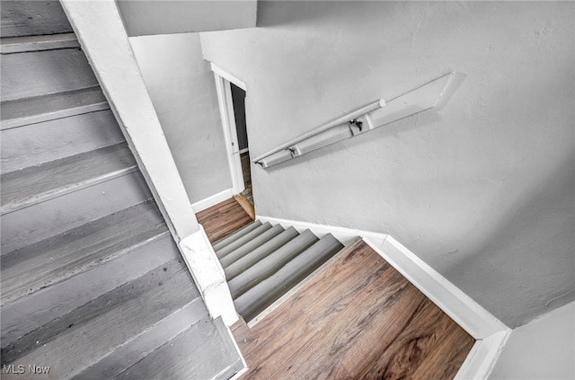 stairway with hardwood / wood-style floors