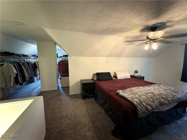 carpeted bedroom featuring ceiling fan, lofted ceiling, a textured ceiling, and a closet