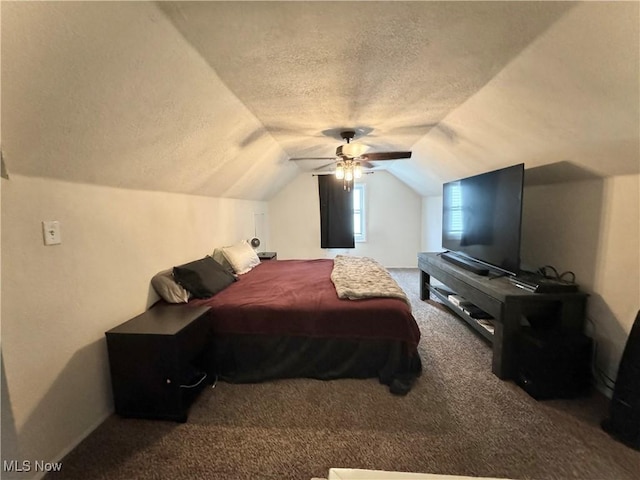 bedroom with a textured ceiling, carpet floors, vaulted ceiling, and ceiling fan