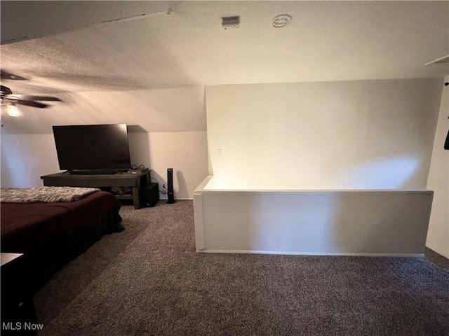 carpeted bedroom featuring ceiling fan and a textured ceiling