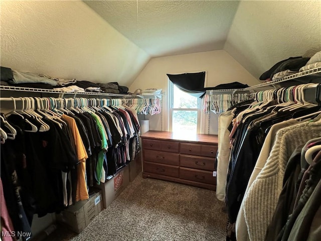 spacious closet featuring carpet flooring and vaulted ceiling