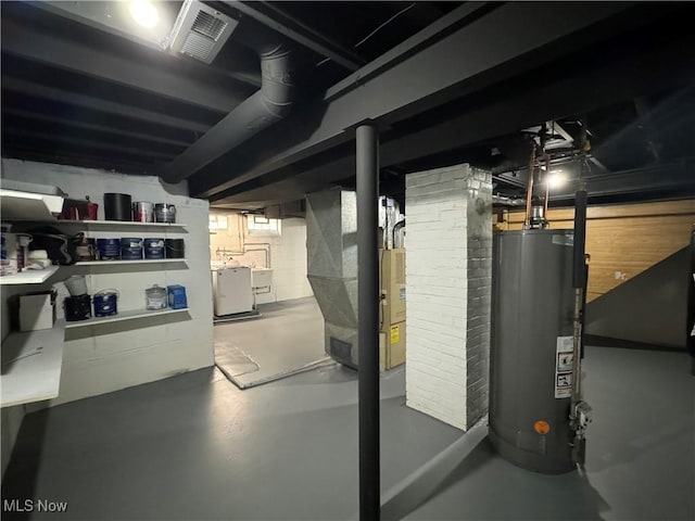 basement with washer and clothes dryer, heating unit, and water heater