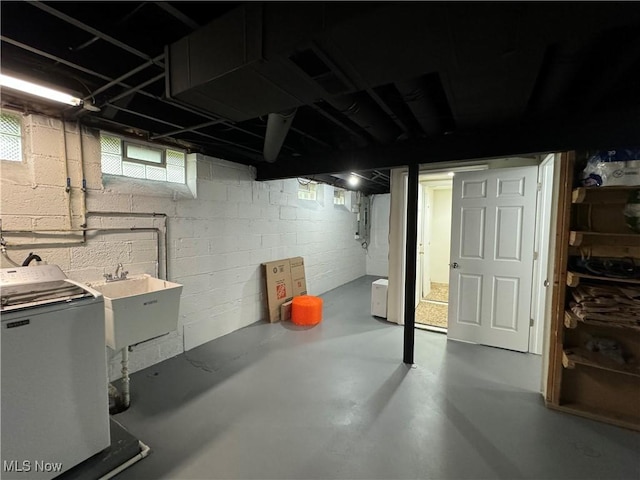 basement with washer / clothes dryer and sink