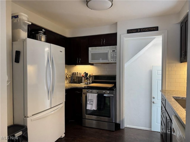 kitchen with backsplash, light stone counters, dark wood-type flooring, and appliances with stainless steel finishes