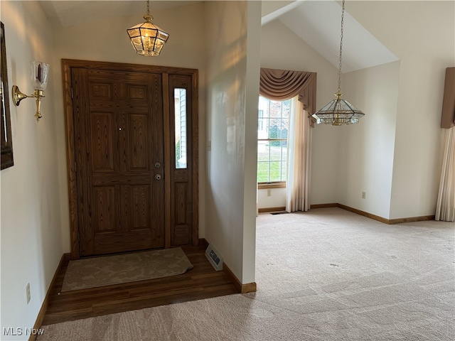 foyer featuring lofted ceiling and carpet floors