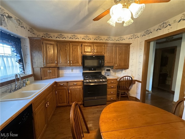 kitchen featuring sink, black appliances, dark wood-type flooring, and ceiling fan