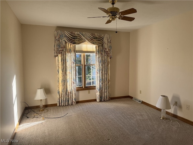 spare room featuring carpet flooring and ceiling fan