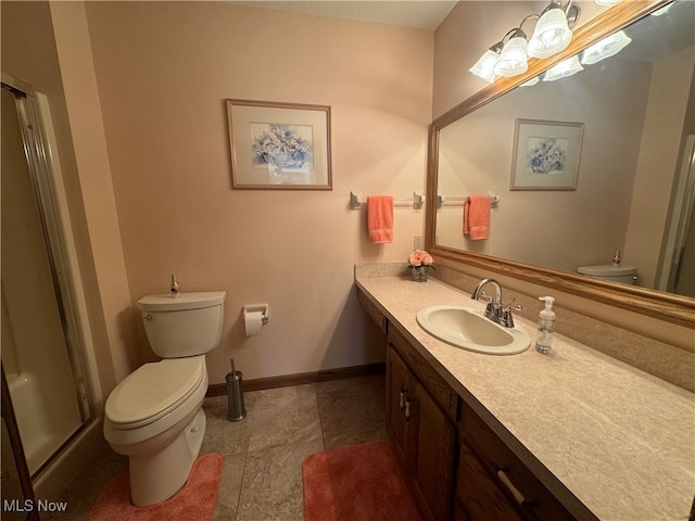 bathroom featuring vanity, toilet, and walk in shower